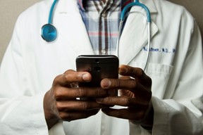 a doctor using his phone to connect with patients
