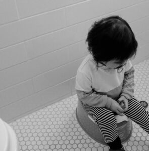 A child sitting on the potty
