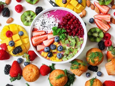 A smoothie bowl surrounded by fruit
