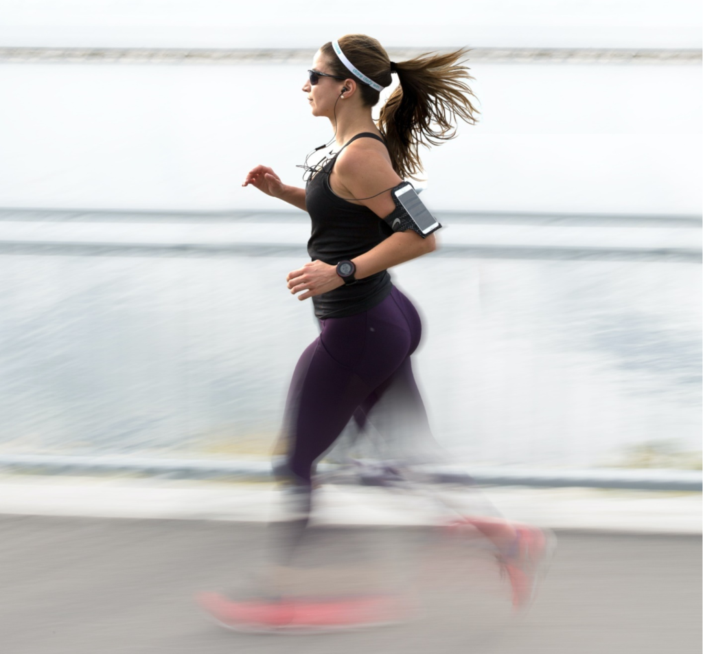 A person jogging wearing a fitness tracker