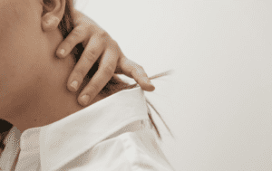 A woman experiencing neck pain
