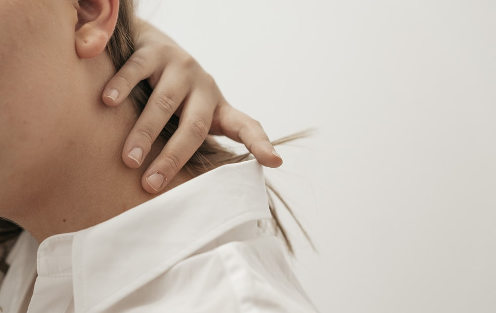 A woman experiencing neck pain