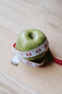 An apple and measuring tape