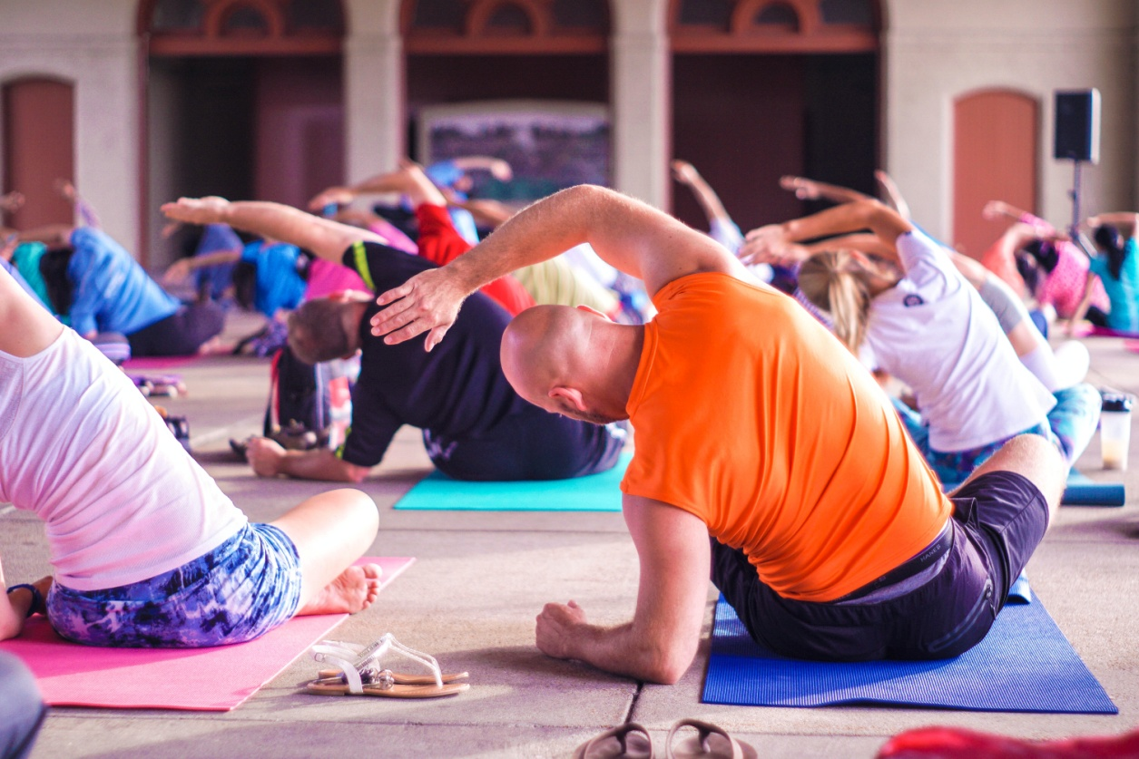 A group of people doing yoga stretch