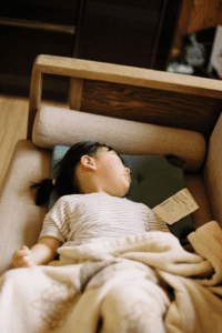 A child sleeping on a sofa